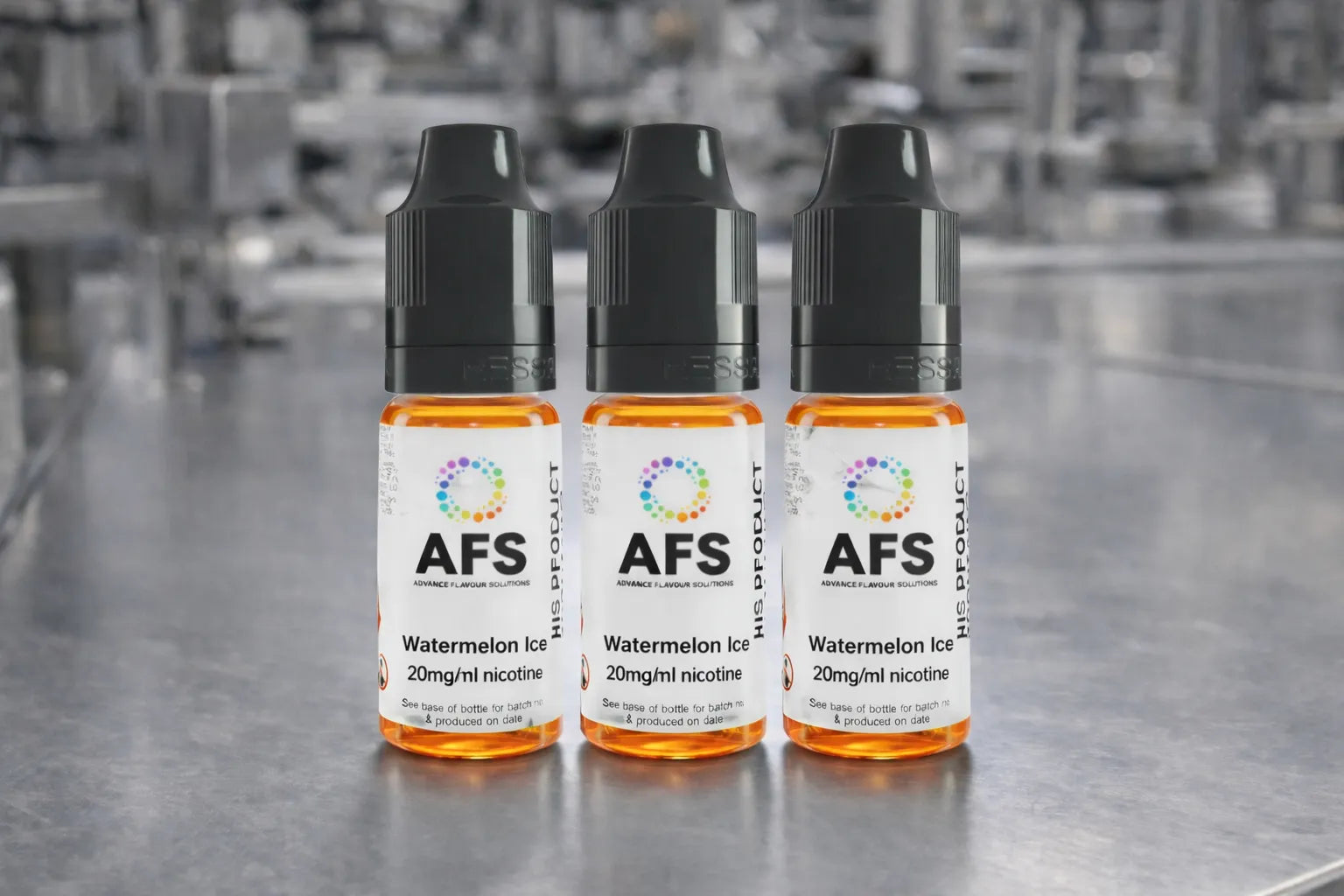 Three AFS e-liquid bottles on a metallic surface with a blurred industrial background.