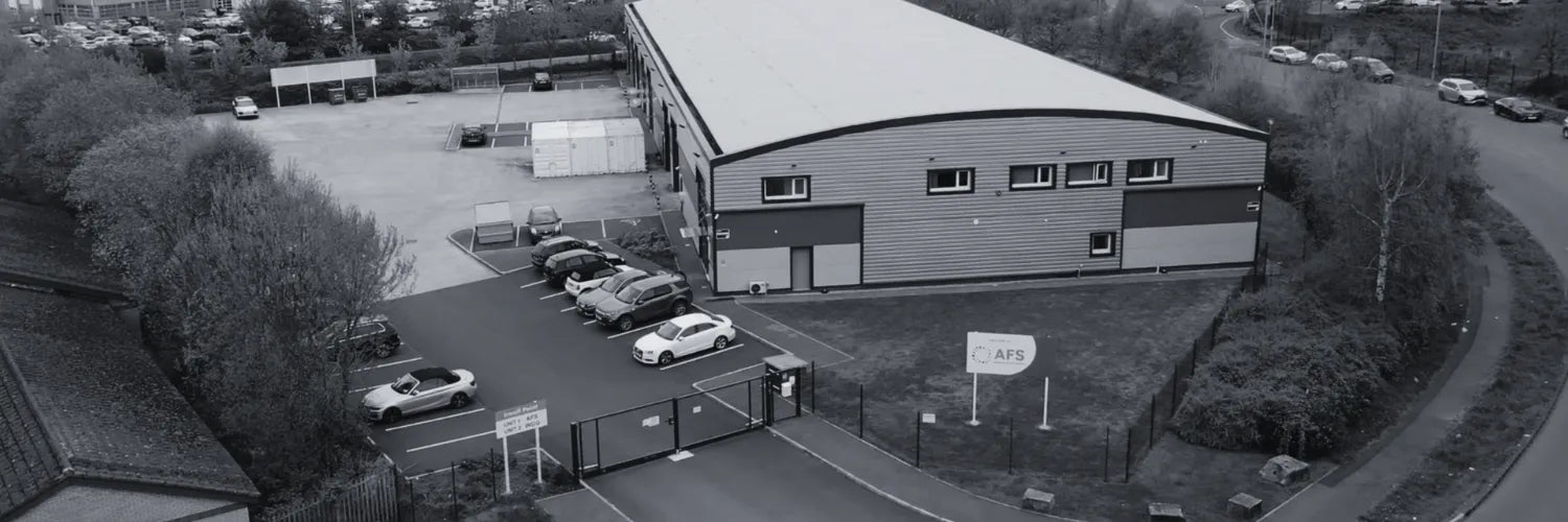Aerial view of Advance Flavour Solutions with a parking area and surrounding trees.