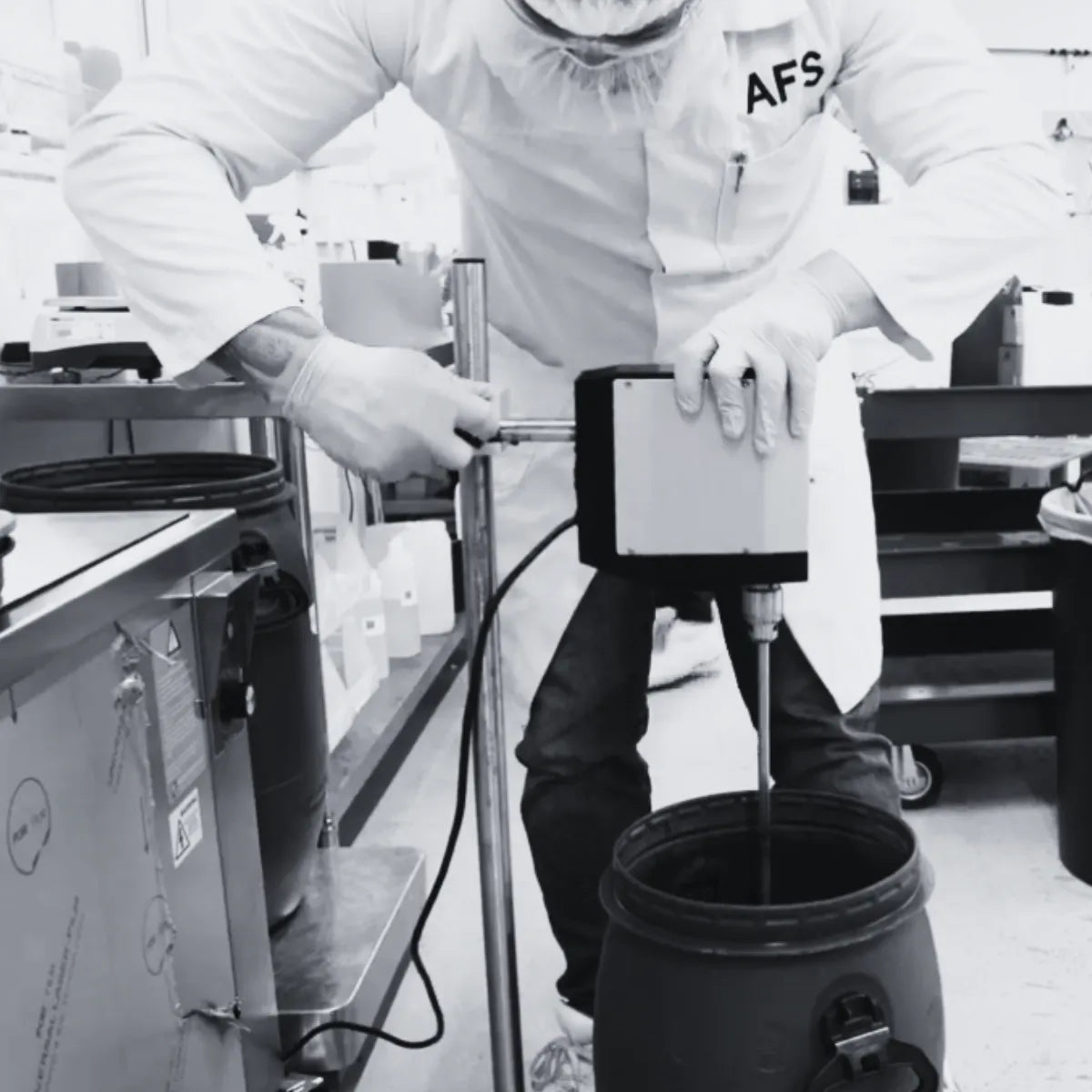 Person in a lab setting using equipment with 'AFS' branding.
